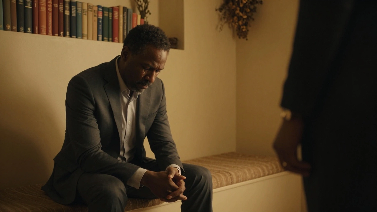 A man in a suit sits tearfully on a bench, listening intently in a serene, non-sexual dominant space.